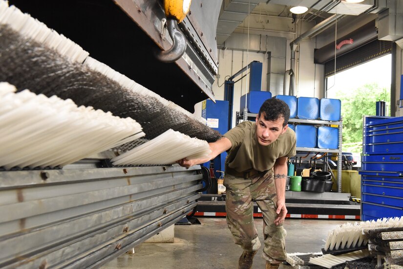 Louisiana Air National Guardsman Staff Sgt. Augusto Villalaz, with the 159th Fighter Wing replaces the brushes on a snow removal truck as part of a deployment for training June 14, 2022. The training is part of a partnership between the the 159th Fighter Wing’s Logistics Readiness Squadron and the 171st Air Refueling Wing. (U.S. Air National Guard Photo by Senior Master Sgt. Shawn Monk)