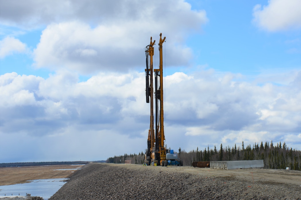 The two machines atop the Moose Creek Dam, a cutter soil mixer and an auger, are being used to mix the existing gravel inside the structure with cement and bentonite to depths of up to 65 feet.