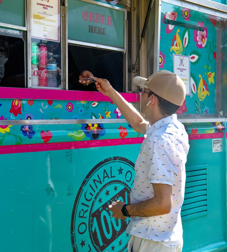 An attendee of the Juneteenth Festival buys food from a food truck at Patriot Park on Peterson Space Force Base, Colorado, June 16, 2022.