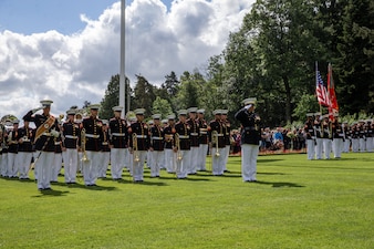 U.S. Marines with the 2nd Marine Division band salute during a ceremony at Aisne-Marne American Cemetery, Belleau, France, May 29, 2022.