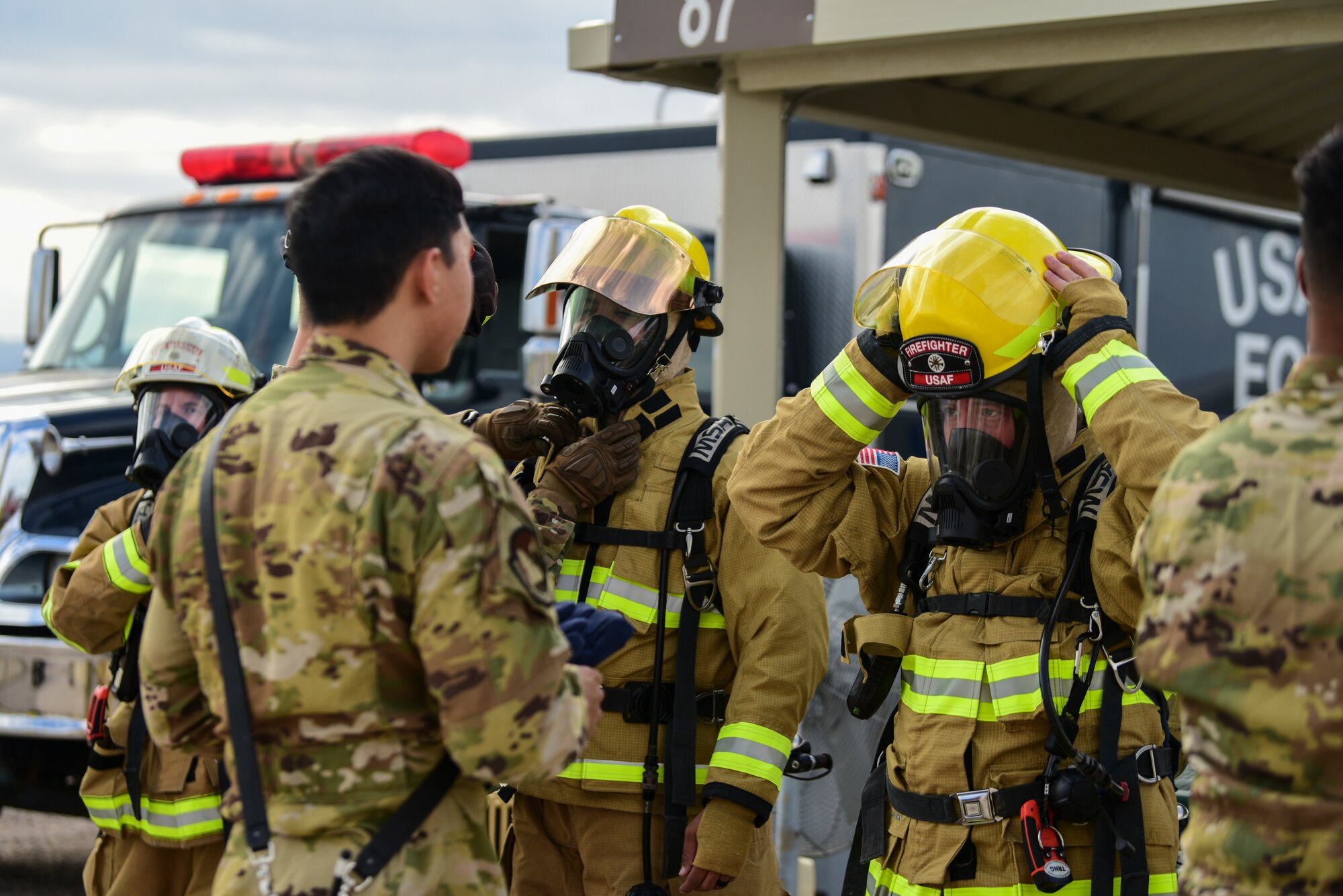 A photo of a fireman getting dressed