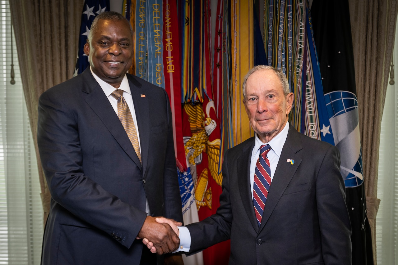 Two men pose for a photo.