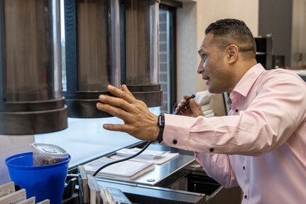 U.S. Army Sgt. 1st Class Sitanimoa Filimoeulie, Training with Industry banking noncommissioned officer student, helps out a customer at the Armed Forces Bank in at Fort Leavenworth, Kan., March 23, 2022. The year-long TWI banking course trains one banking officer and one NCO each year, but with a need to train more finance and comptroller Soldiers in banking operations, the U.S. Army Financial Management Command created a new banking short course to train up to 18 Soldiers per year. (U.S. Army photo by Mark R. W. Orders-Woempner)