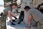 U.S. Air Force Staff Sgt. Rhyan Acey (left) and Staff Sgt. Isaiah Servantez perform maintenance on the AN/TSQ-180 Milstar Communications Vehicle July 30, 2021, at the 233rd Space Group, Greeley Air National Guard Station, Greeley, Colorado. GANGS was the first National Guard unit to assume an Air Force Space Command mission. (U.S. Air National Guard photo by Master Sgt. Amanda Geiger)