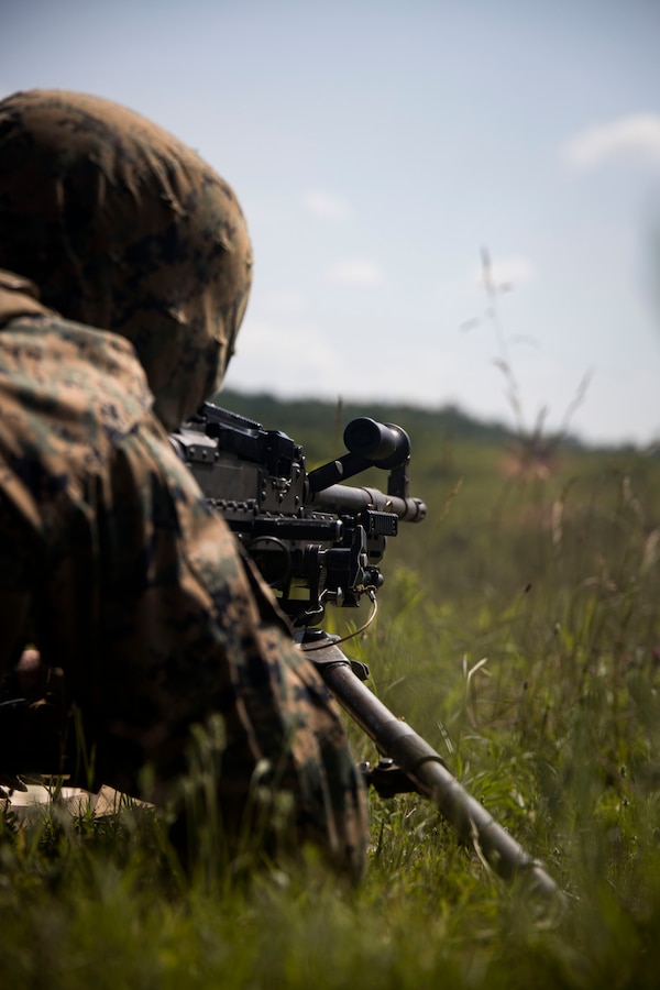 Private First Class Jonathan Buck, Guard Company, Marine Barracks Washington, fires the M240B machine gun during a live-fire range at Marine Corps Base Quantico, Va., June 15, 2022. The range consisted of training with the M240B machine gun, while suppressing fire and denying the enemy from establishing firing positions for their fire support assets. The training hones the Marines capabilities as a squad that is capable of responding to a potential crisis or contingency. (U.S. Marine Corps photo by Cpl. Mark Morales)