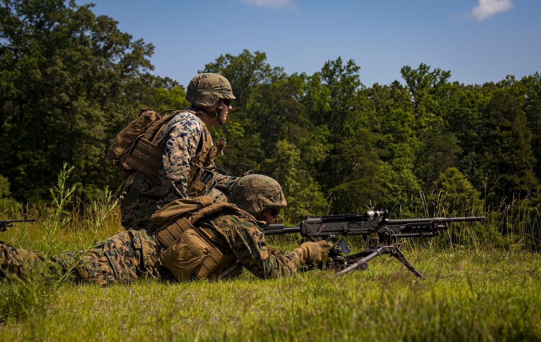 Corporal Clayton C. Dupuy, Guard Company, watches over the machine gunner during a support live-fire at Marine Corps Base Quantico, Va., June 15, 2022.