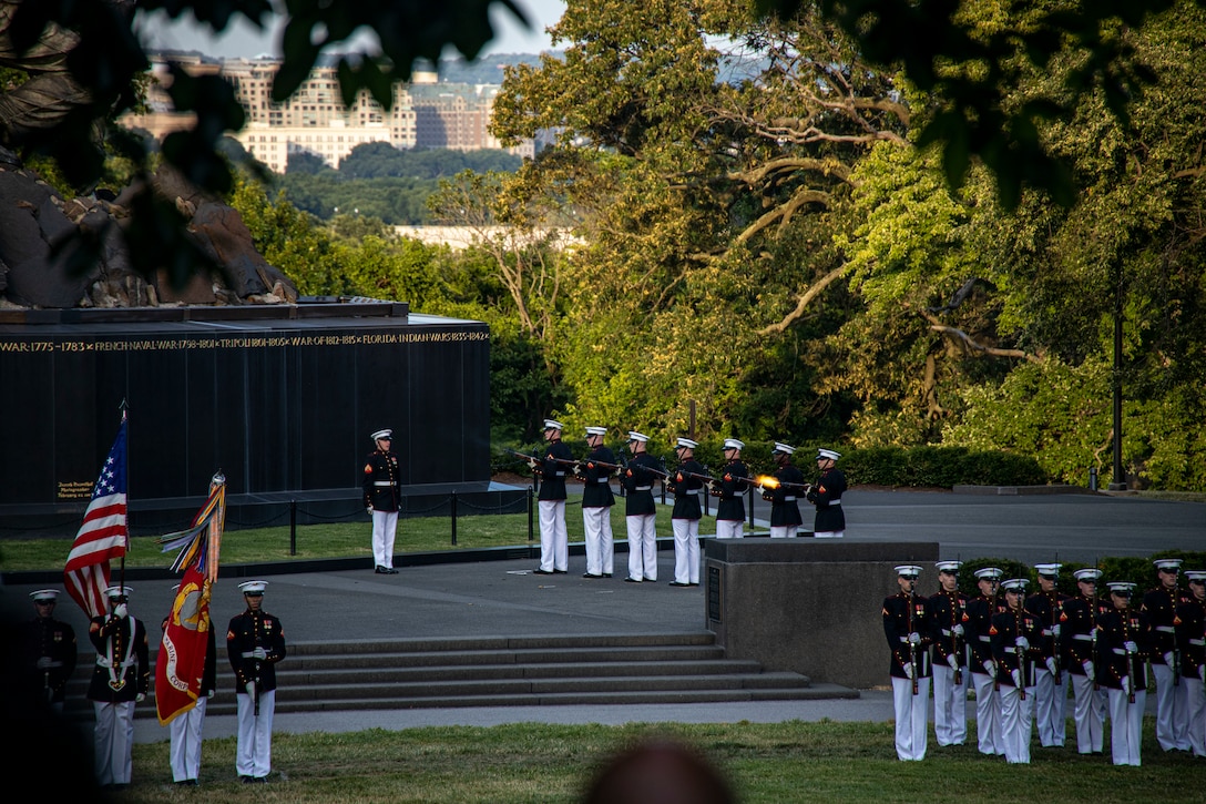 Marines with Marine Barracks Washington conduct a “three-round volley” during a Sunset Parade at the Marine Corps War Memorial, Arlington, Va., June 21, 2022.