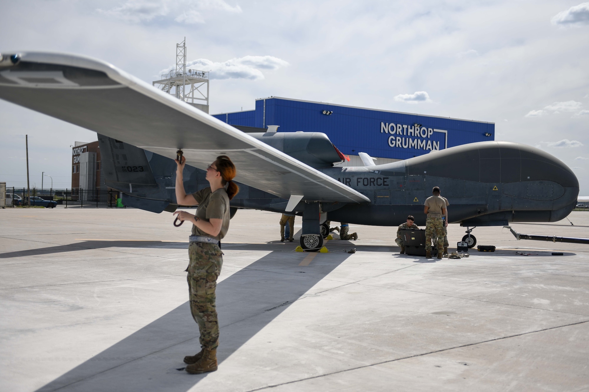 Airmen assigned to the 319th Aircraft Maintenance Squadron from Grand Forks Air Force Base, North Dakota, perform a maintenance check June 6, 2022, on an RQ-4 Block 30 Global Hawk remotely piloted aircraft at Grand Sky on Grand Forks Air Force Base. The RQ-4 Block 30s will be used at the Test Resource Management Center’s High Speed System Test Department. Located on Grand Forks Air Force Base, Grand Sky is a business and aviation park focused on developing and growing the unmanned aerial systems industry. (U.S. Air Force photo by Senior Airman Ashley Richards)