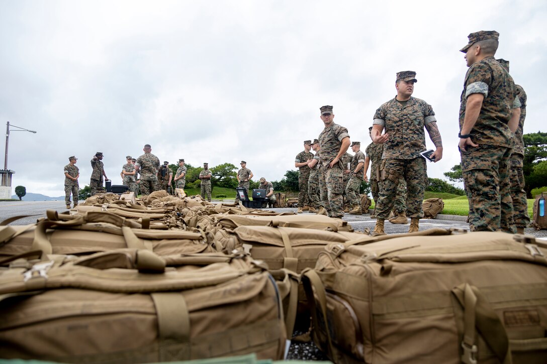 U.S. Marines with 3d Marine Expeditionary Brigade (3D MEB) Alert Contingency Marine (ACM) Air Ground Task Force, stand-by to load gear into a Medium Tactical Vehicle Replacement truck for transportation to Marine Corps Air Station Futenma during an ACM drill on Camp Courtney, Okinawa, Japan, June 8, 2022. 3D MEB is III Marine Expeditionary Force’s Fire Brigade, ready to respond to a wide range of crisis events throughout the Indo-Pacific region as a command-and-control node or as the nucleus of a Joint Task Force, from delivering humanitarian assistance during natural disasters to combat operations. This ACM drill showcased the 3D MEB’s readiness and validated its ability to rapidly activate and deploy a Forward Command Element. (U.S. Marine Corps photos by Cpl. Francesca Landis)