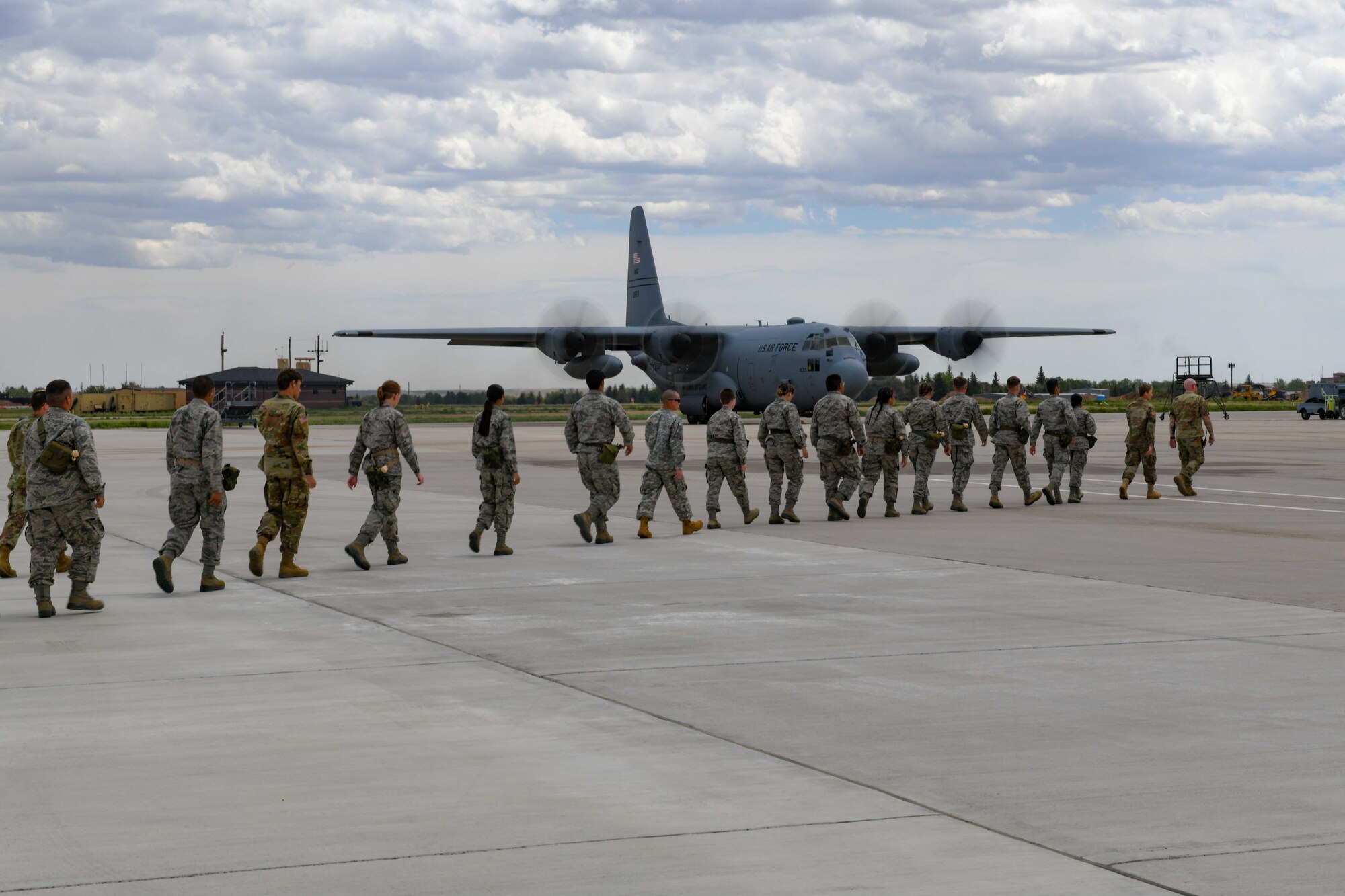 Army and Air Force Junior ROTC Cadets prepare to board a C-130 Hercules at Cheyenne Regional Airport, Cheyenne, Wyoming June 9, 2022. Cadets walked in a line to safely enter the aircraft. (U.S. Air Force photo by Airman 1st Class Landon Gunsauls)