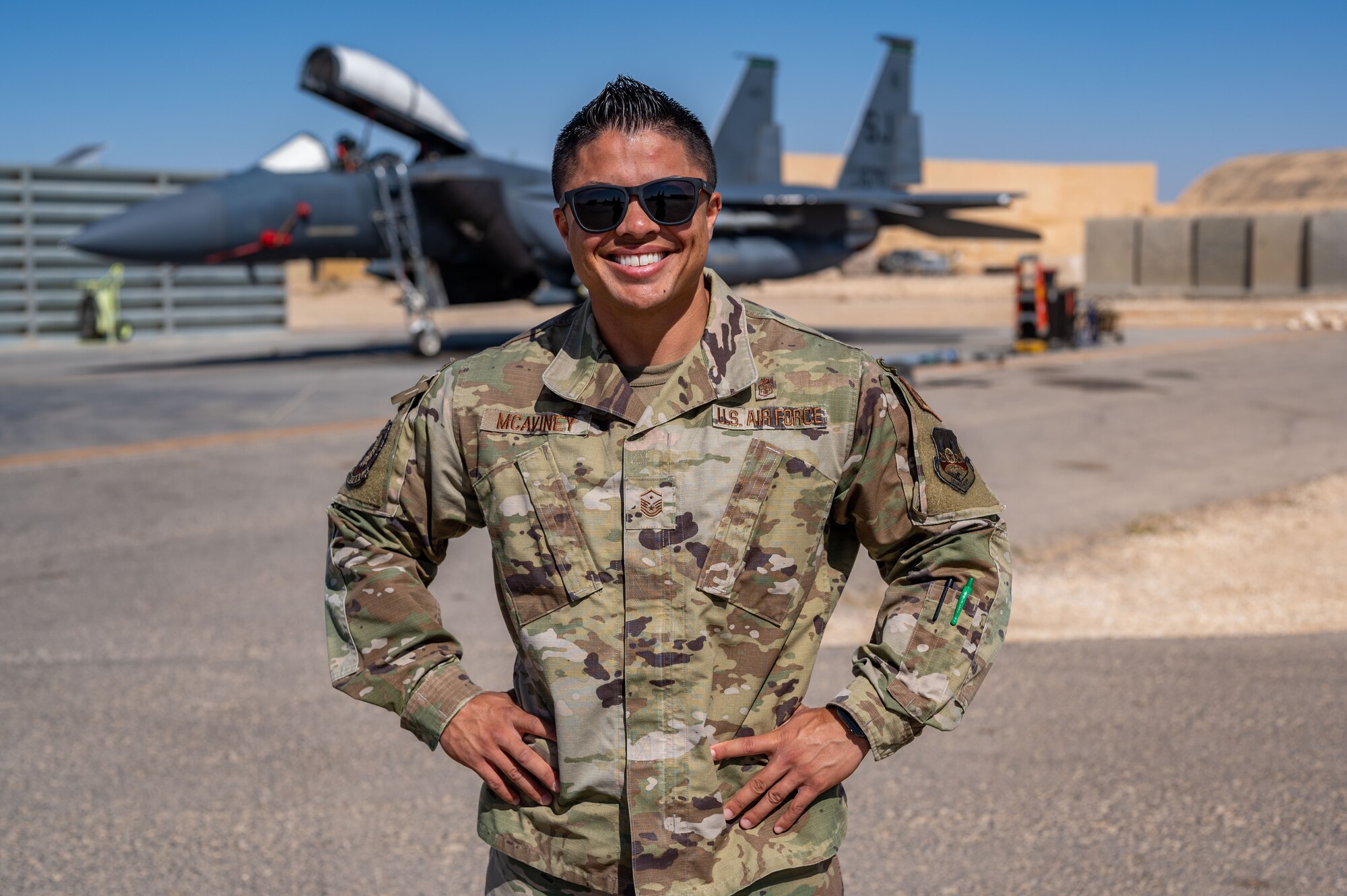 Master Sgt. Kayleigh McAviney, 335th Fighter Generation Squadron first sergeant, poses in front of an F-15E Strike Eagle assigned to Seymour Johnson Air Force Base, North Carolina, while at her deployed location in Southwest Asia June 20, 2022. This is her seventh deployment, and she and her wife have faced many challenges together, having never been together for longer than nine consecutive months throughout their entire relationship. (U.S. Air Force photo by Master Sgt. Kelly Goonan)
