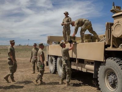 Soldiers of the 213th Forward Support Company, 65th Field Artillery Brigade, Utah National Guard unload crates of ammunition during Western Strike 22 at Orchard Combat Training Center, Idaho, June 10, 2022.