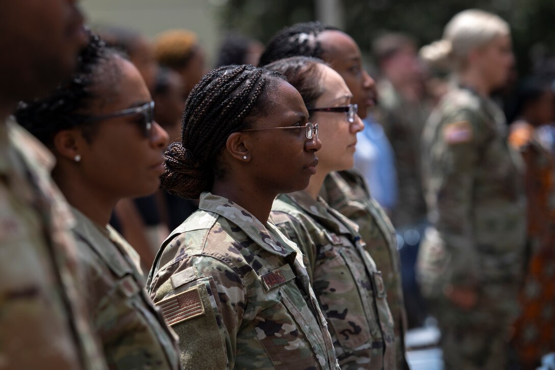 Airmen stand at attention as the National Anthem is sung during a Juneteenth Celebration at the Pentagon in Arlington, Va., June 21, 2022. The celebration was hosted to recognize the contributions and heritage of the Black community in the United States, and to share priorities the Department of the Air Force has for building a more inclusive and diverse force. (U.S. Air Force photo by Staff Sgt. Elora J. McCutcheon)