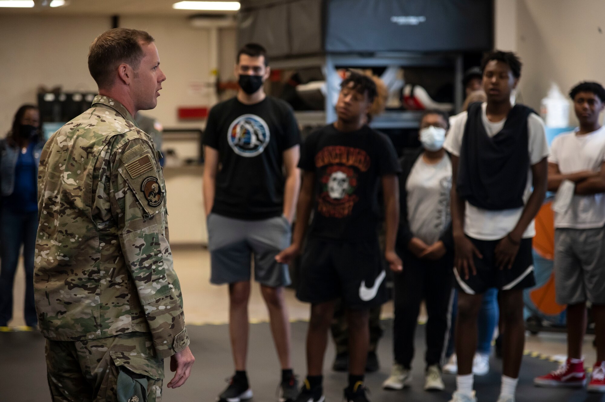 Tech. Sgt. Derreck Day, 436th Operations Support Squadron Survival, Evasion, Resistance, Escape specialist, talks to students from the Organization of Black Aerospace Professionals during an immersion tour at Dover Air Force Base, Delaware, June 21, 2022. The OBAP group toured and interacted with several units on Dover AFB and gained knowledge on different aspects of the aviation career field. (U.S. Air Force photo by Staff Sgt. Marco A. Gomez)