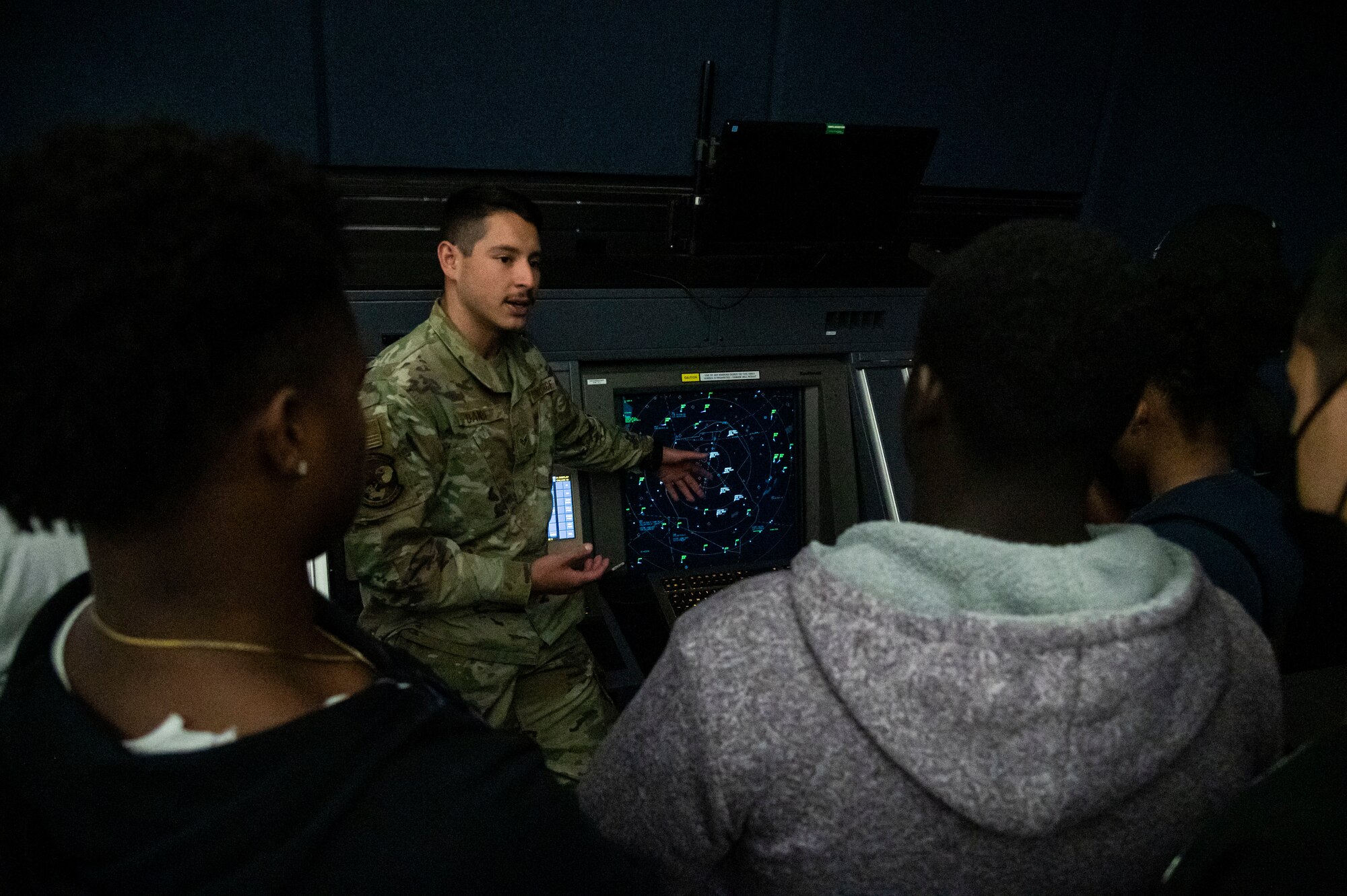 Senior Airman Zachary Bande, 436th Operations Support Squadron air traffic control journeyman, shows a flight radar to students from the Organization of Black Aerospace Professionals during an immersion tour at Dover Air Force Base, Delaware, June 21, 2022. OBAP’s mission is to inspire excellence and provide opportunities in aerospace by supporting, transforming, educating and mentoring members and communities. (U.S. Air Force photo by Staff Sgt. Marco A. Gomez)