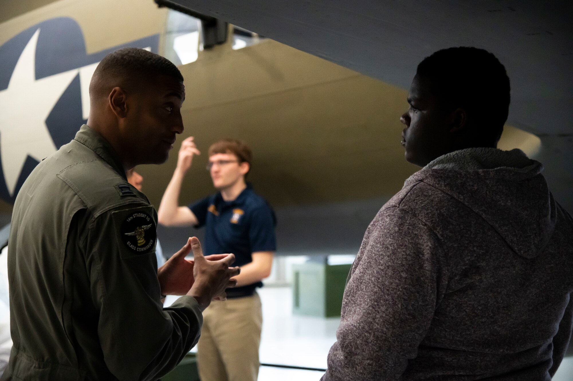 Capt. Matthew Jones, 14th Student Squadron T-6 instructor pilot, talks to a student from the Organization of Black Aerospace Professionals during an immersion tour at the Air Mobility Command Museum in Dover, Delaware, June 21, 2022. Along with being the assigned group mentor, Jones gave students personal insight into the military lifestyle and his own experiences as a member of the aviation community in the Air Force. (U.S. Air Force photo by Staff Sgt. Marco A. Gomez)