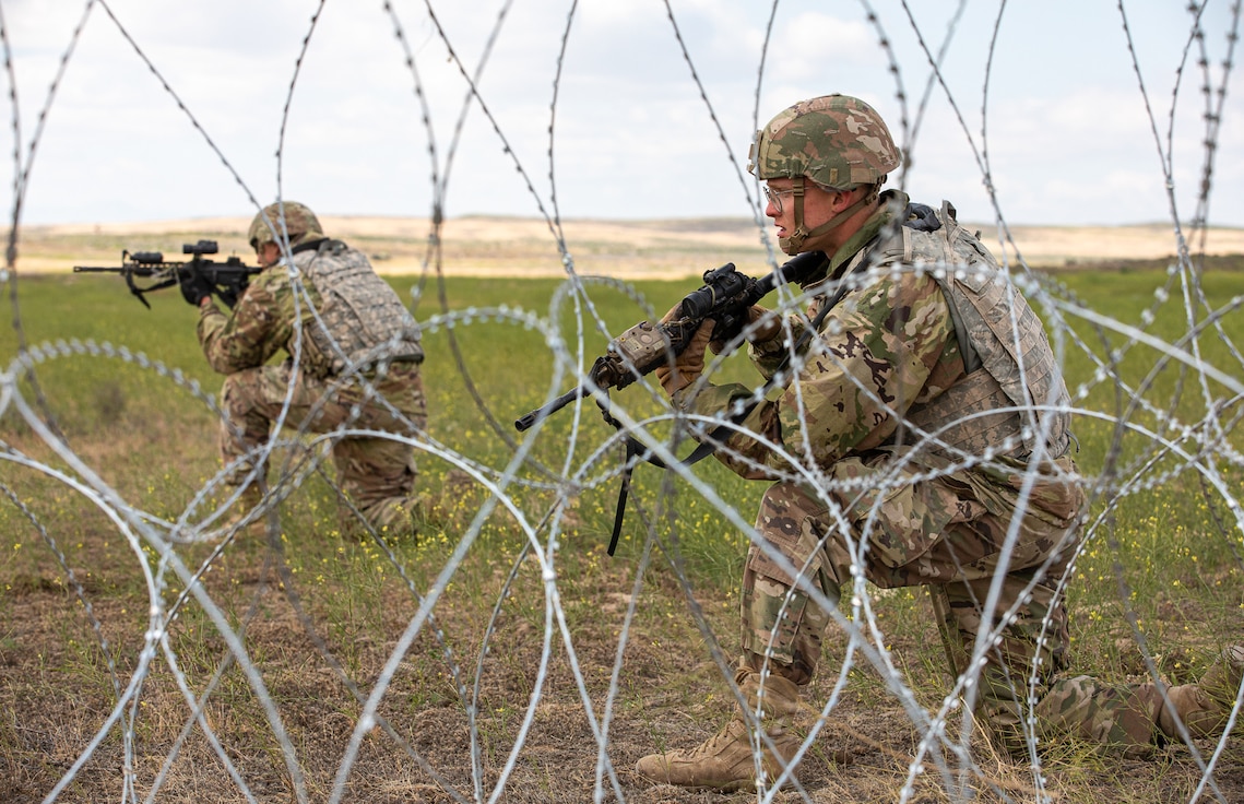 Spc. Connor Crabil and Pfc. Corbin Wolfe, combat engineers with the 883rd Engineer Company, Iowa National Guard, pull security for their platoon during Western Strike 22, at Orchard Combat Training Center, Idaho, June 14, 2022.
