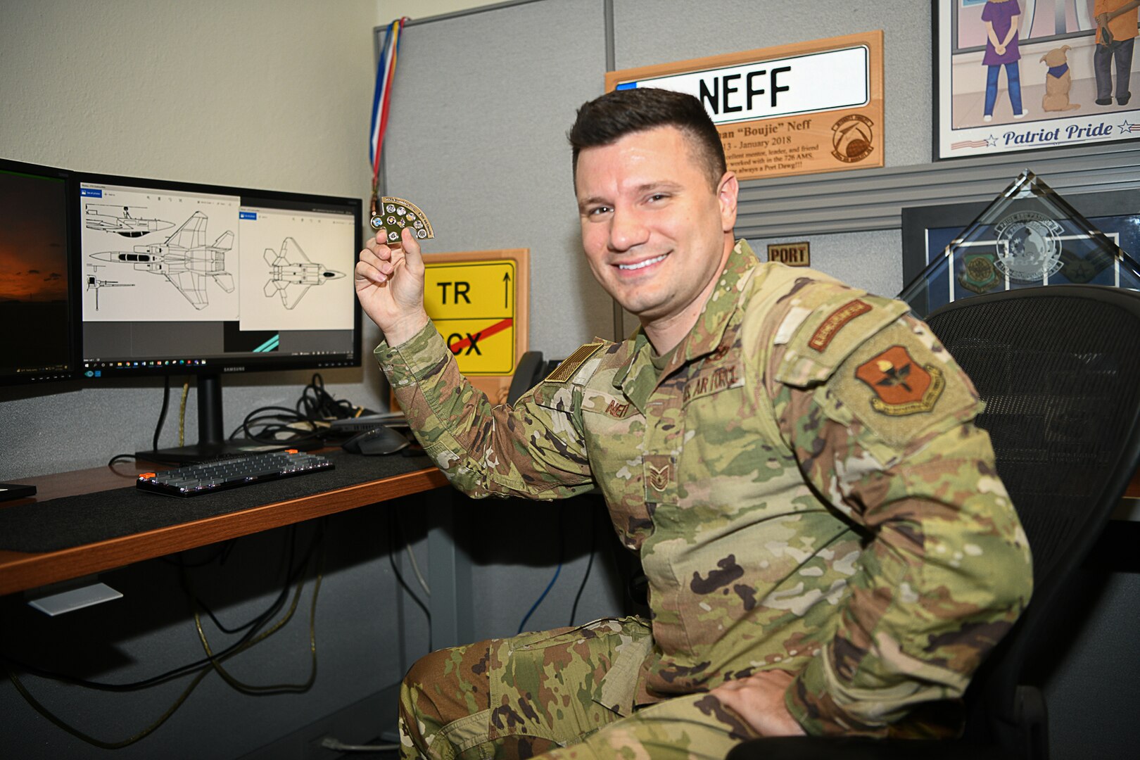 Tech. Sgt. Jonathan Neff, enlisted standards non-commissioned officer in AFRS’s Operations Division displays the prototype of a “puzzle coin” he is designing for the 2022 Commander’s Cup Challenge, June 17, 2022.