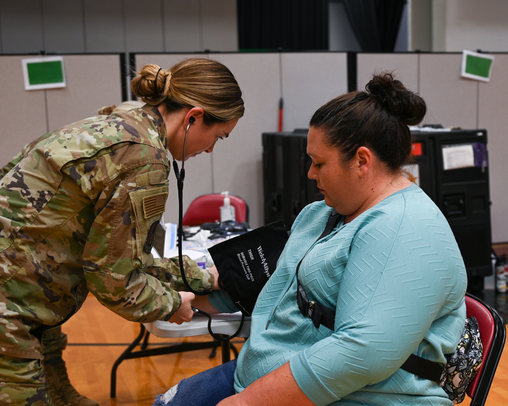 Medic takes patient's vitals inside clinic.