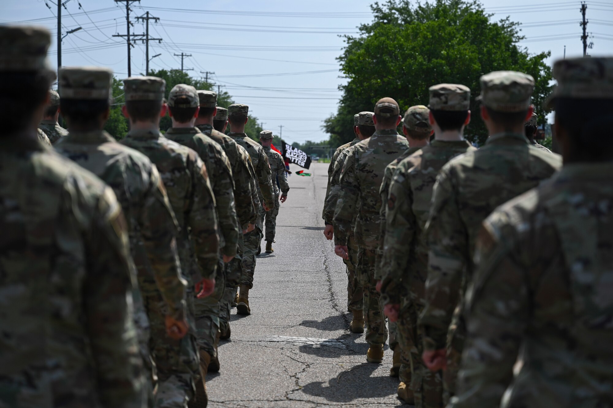 U.S. Air Force service members assigned to Columbus Air Force Base, march in the 25th Annual Juneteenth Parade Festival, June 18, 2022. This is the first year the base has participated with the community at the parade. (U.S. Air Force photo by Senior Airman Jessica Haynie)
