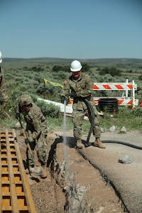 Horizontal construction engineers with the 116th Engineer Company, 1457th Engineer Battalion, Utah National Guard finalize the installation of a new cattle guard at Dinosaur National Monument, June 13, 2022