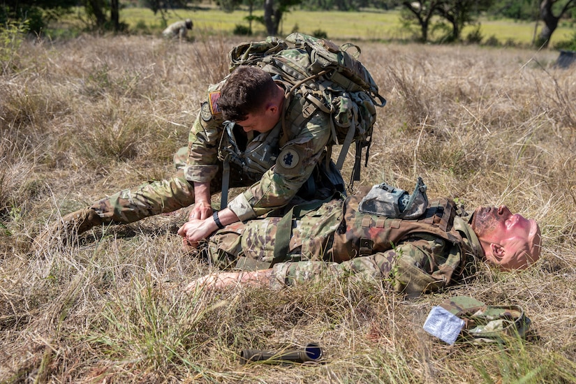 Spc. Sean Doyle, a squad member representing the U.S. Army South's best squad competition team puts on his M50 gas mask during the medical lane during the Army Futures Command 2022 Best Squad Competition on June 7, 2022 at Camp Bullis, Texas. The Best Squad Competition is being used to select the team that will represent their command at the next level of competition with the hope of eventually winning the inaugural U.S. Army level Best Squad Competition