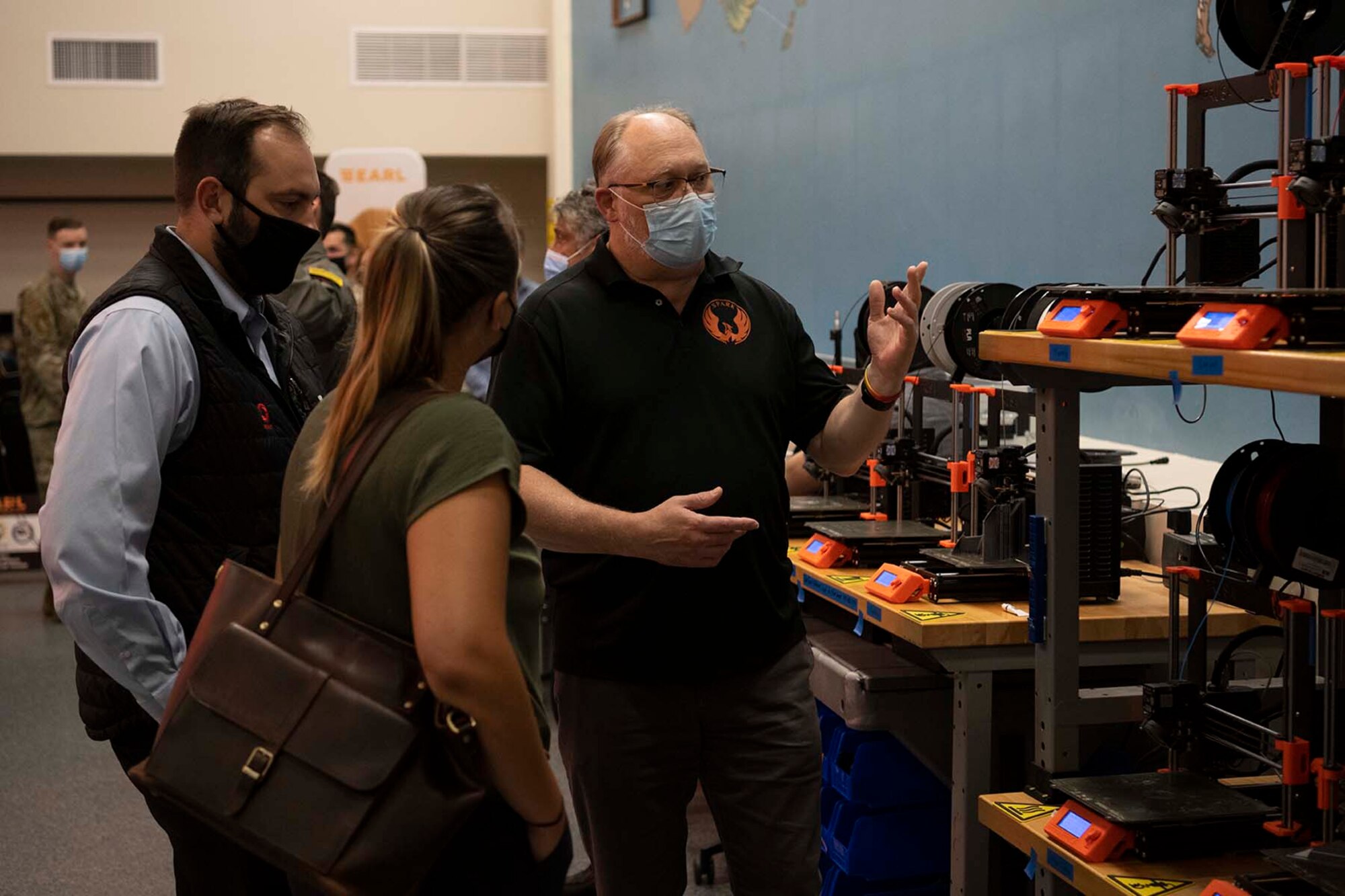 A spark employee speaks with visitors