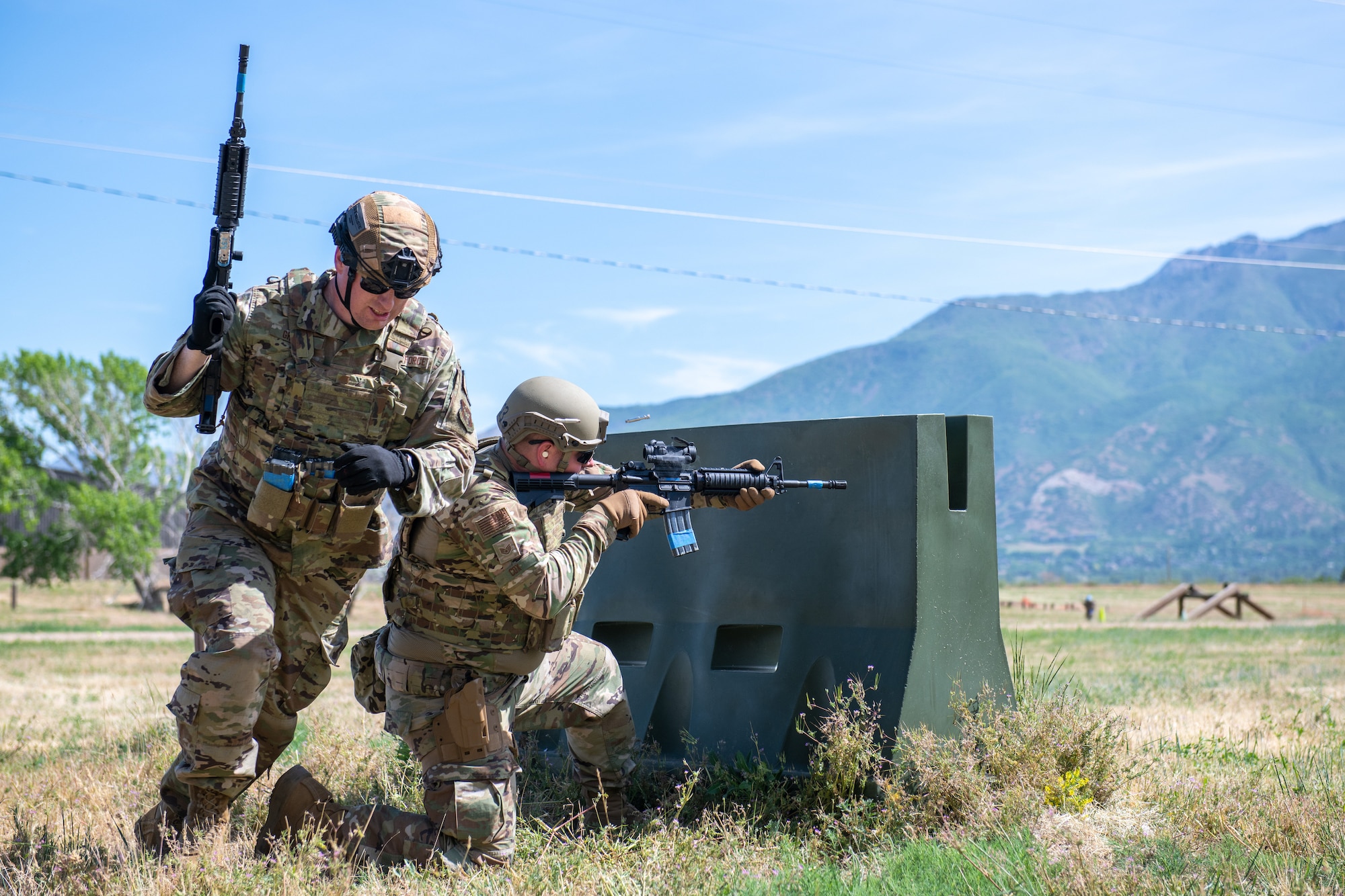 Staff Sgt. Kallen Cox, 419th Security Forces combat arms instructor, provides cover for Tech. Sgt. Nicholas Gribble during their “Shoot, Move, Communicate” exercise at Hill Air Force Base, Utah on June 11, 2022. The exercise is part of their annual weapons training plan, ensuring Airmen remain proficient in not only marksmanship, but how to move and communicate effectively when engaged with a target. (U.S. Air Force photo by Senior Airman Erica Webster)