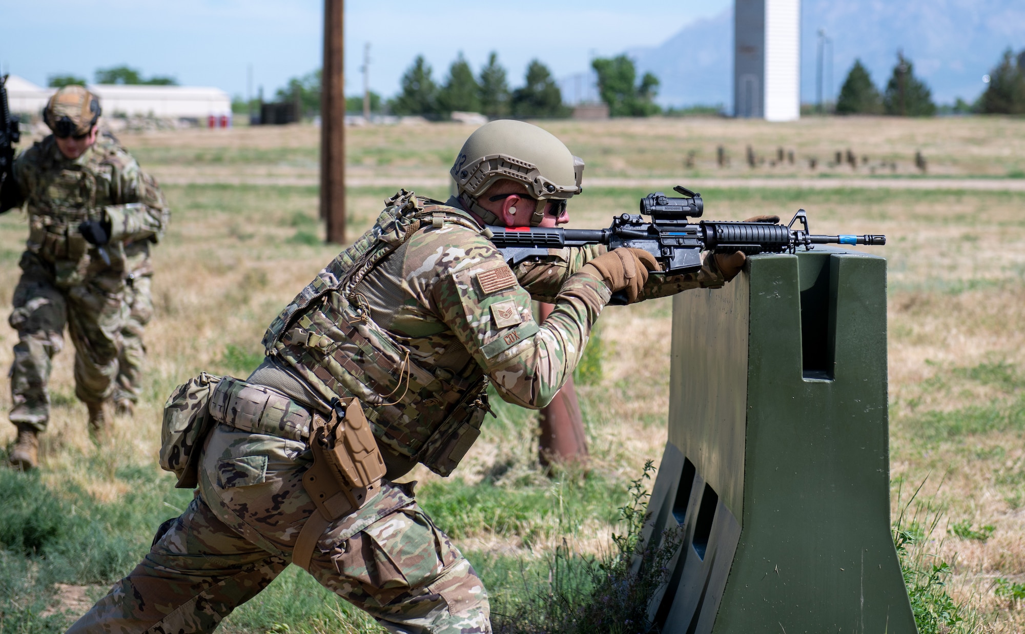 Staff Sgt. Kallen Cox, 419th Security Forces combat arms instructor, takes aim at a target while providing cover for his partner during a “Shoot, Move, Communicate” exercise at Hill Air Force Base, Utah on June 11, 2022. The exercise is part of their annual weapons training plan, ensuring Airmen remain proficient in not only marksmanship, but how to move and communicate effectively when engaged with a target. (U.S. Air Force photo by Senior Airman Erica Webster)