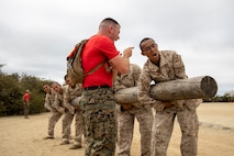 U.S. Marine Corps recruits, with Delta Company, 1st Recruit Training Battalion, conduct side bends during log drills at Marine Corps Recruit Depot San Diego, June 13, 2022