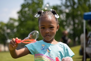 A military child plays with bubbles during the Juneteenth Family Reunion event at Misawa Air Base, Japan, June 18, 2022.