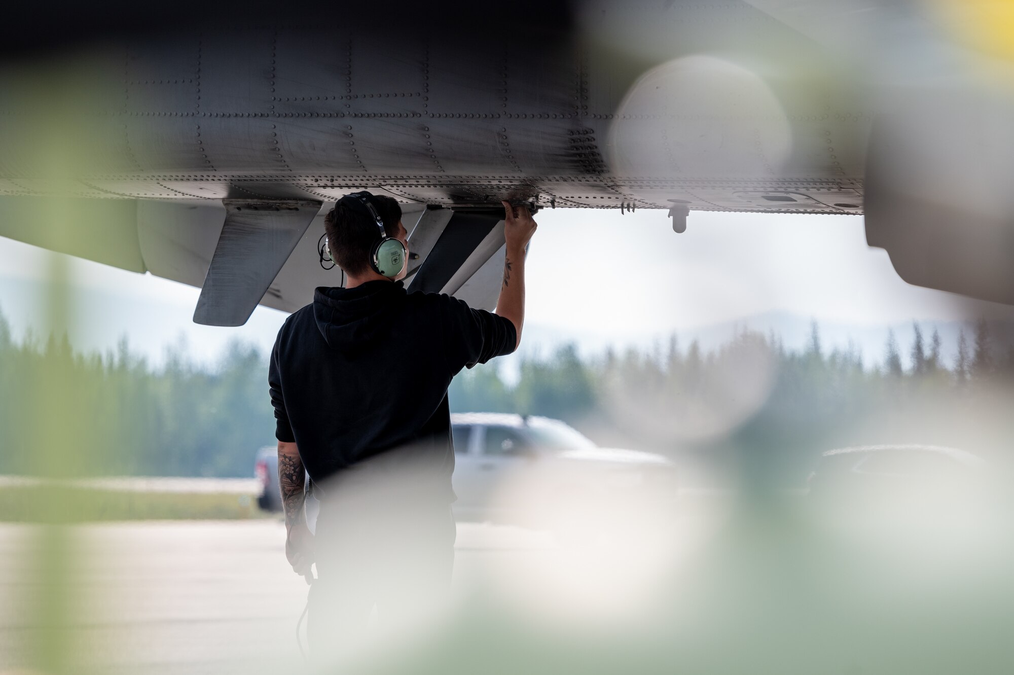 U.S. Air Force Staff Sgt. Jason Moore, 25th Fighter Generation Squadron crew chief, closes exterior panels of an A-10 Thunderbolt II during preflight procedures