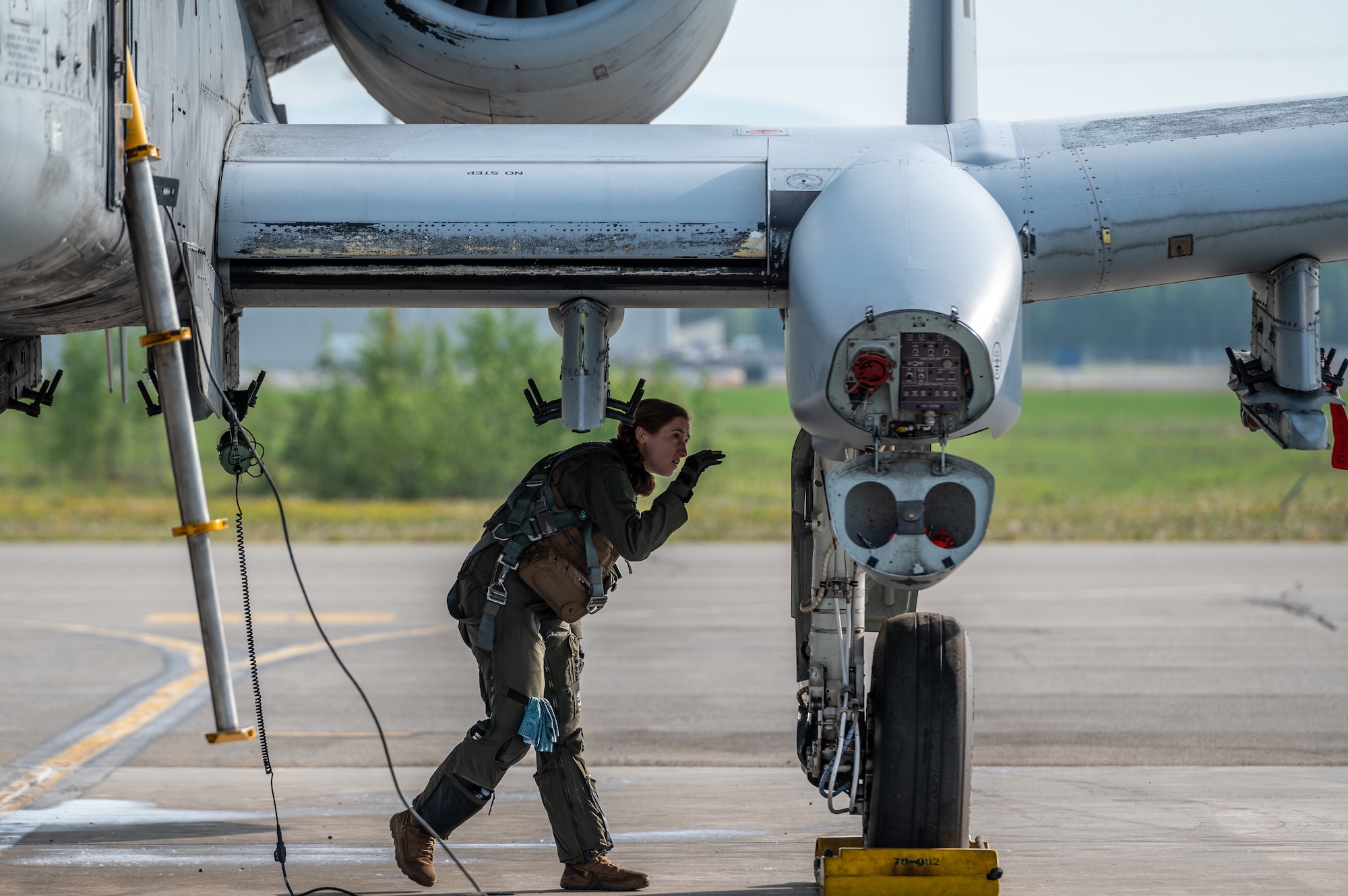 U.S. Air Force Capt. Colleen “Cloud” Engelbrecht, 25th Fighter Squadron pilot, inspects the exterior of an A-10 Thunderbolt II