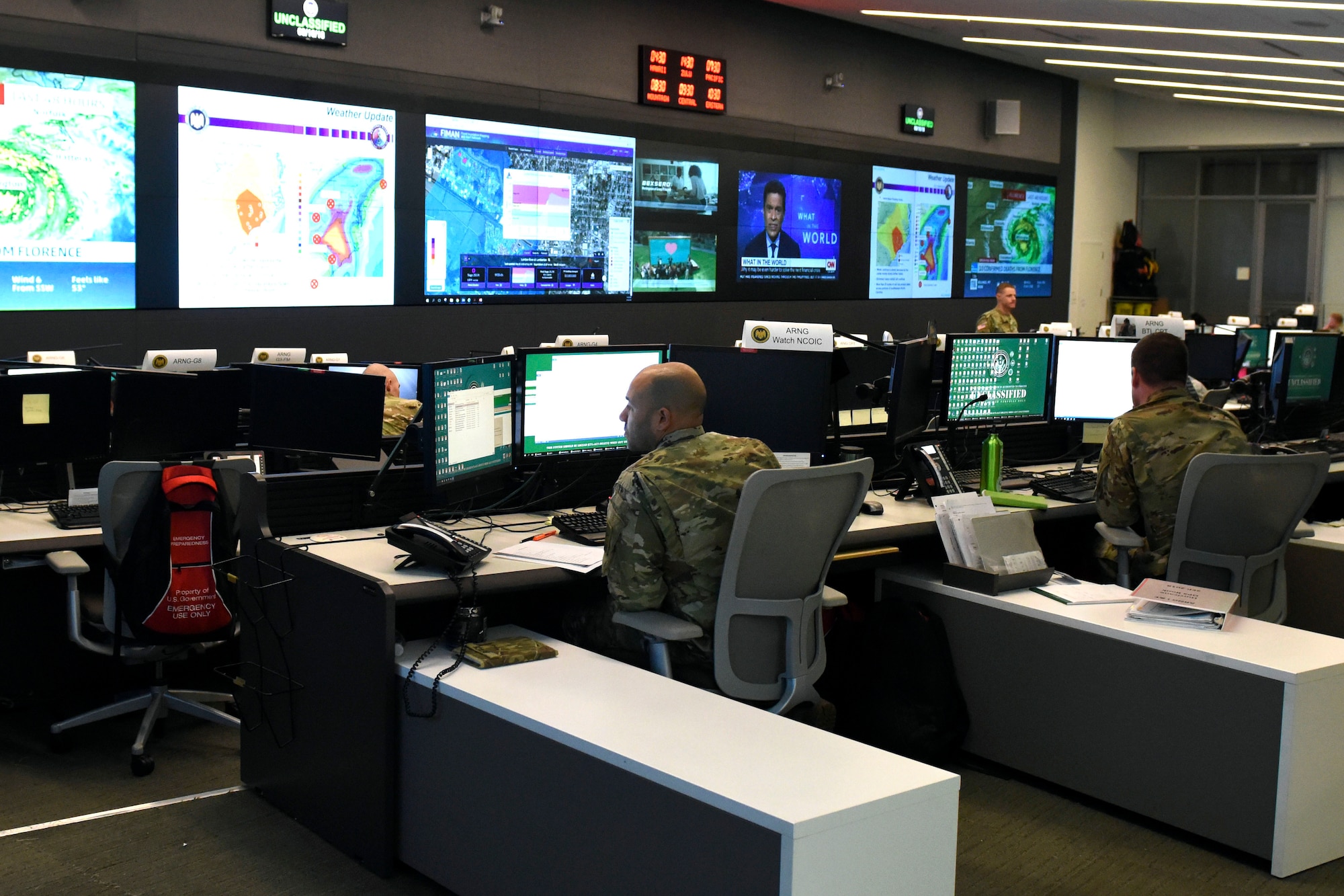 Television screens illuminate what would otherwise be a darkened underground facility at the National Guard Coordination Center, or NGCC, in Arlington, Virginia, in July 2020.  In May 2022, the NGCC, along with the operations directorates of various National Guard elements, were instrumental in the delivery of the German Ministry of Defense’s SARah satellite from Baltimore to Vandenberg Space Force Base, California, for its June 18 launch into space.