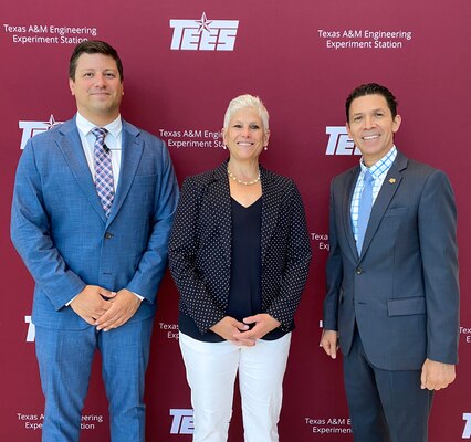 Three individuals stand shoulder-to-shoulder in front of a backdrop that says "Texas A&M Engineering Experiment Station."