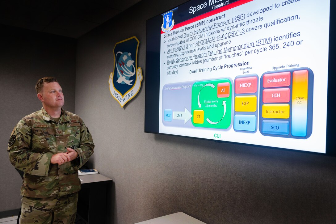 U.S. Air Force Tech. Sgt. Josh Cheney, 216th Space Control Squadron space control operator (SCO), instructs a training mission slide June 22, 2022, at Vandenberg Space Force Base, Calif. In addition to his SCO responsibilities, Cheney often trains Airmen to increase readiness for future deployments. (U.S. Space Force photo by Tech. Sgt. Luke Kitterman)