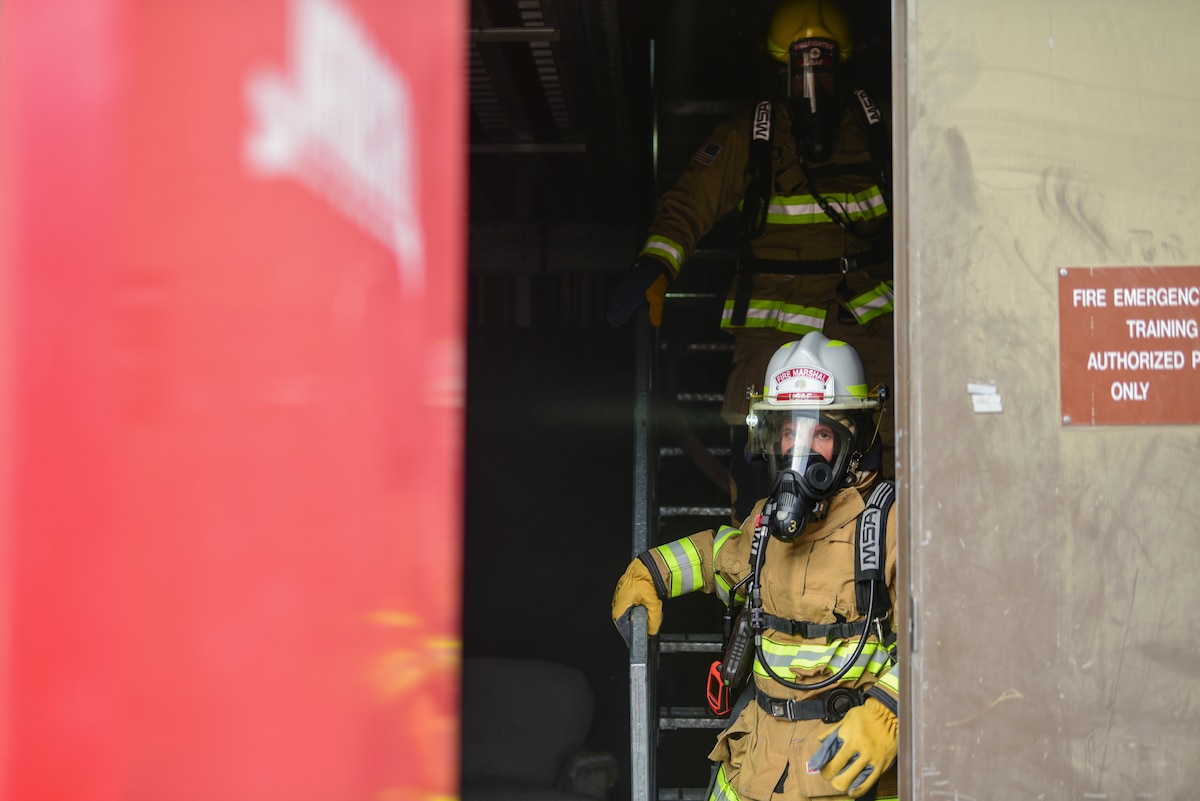 A photo of a fireman coming out of a building