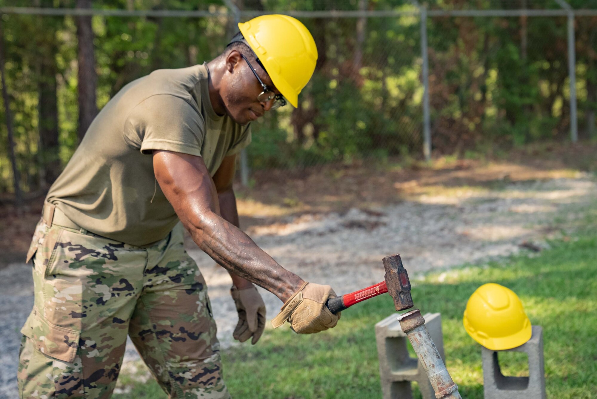 An Airman nails down a grounding pole.