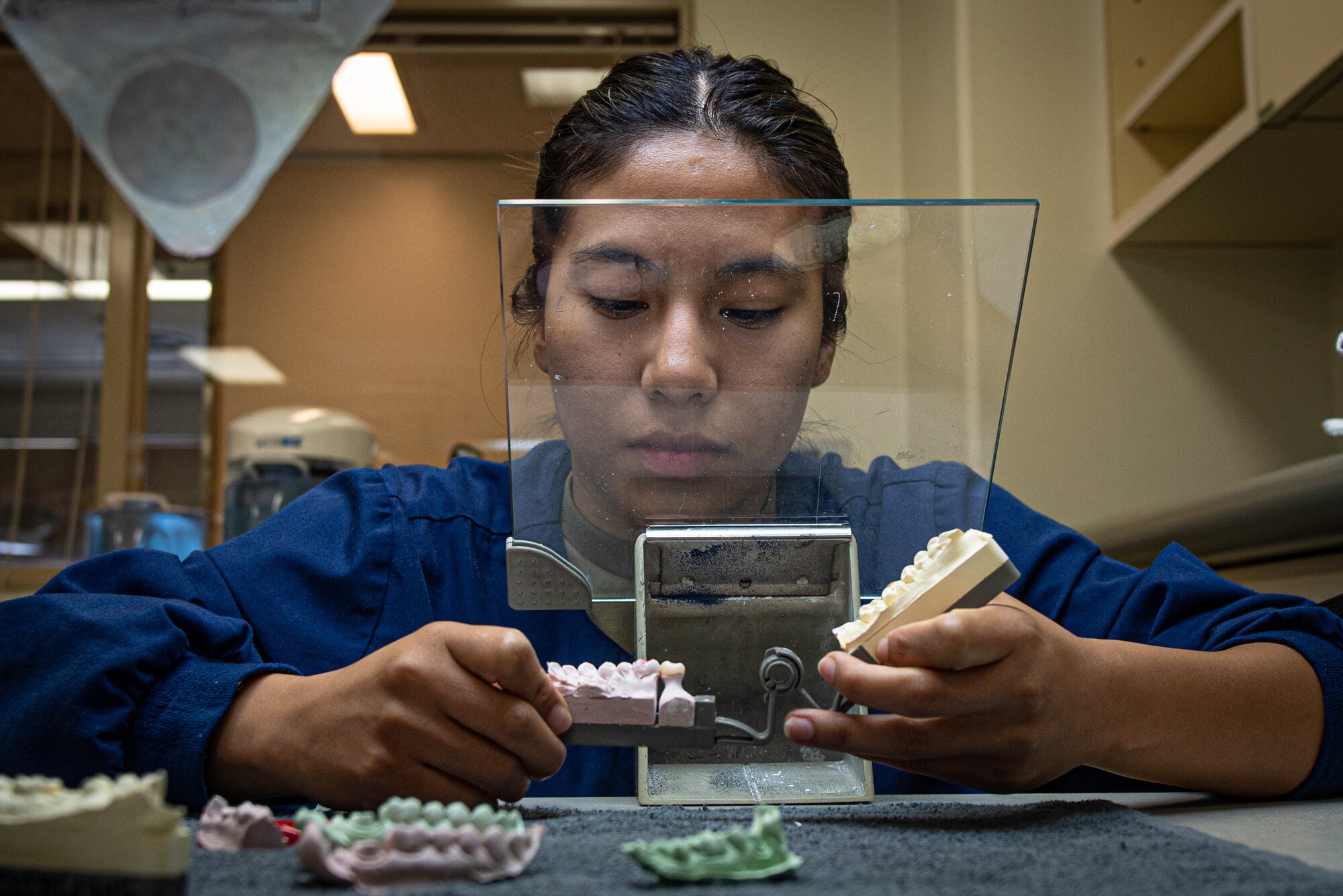 An Airman checks a crown for a tooth.
