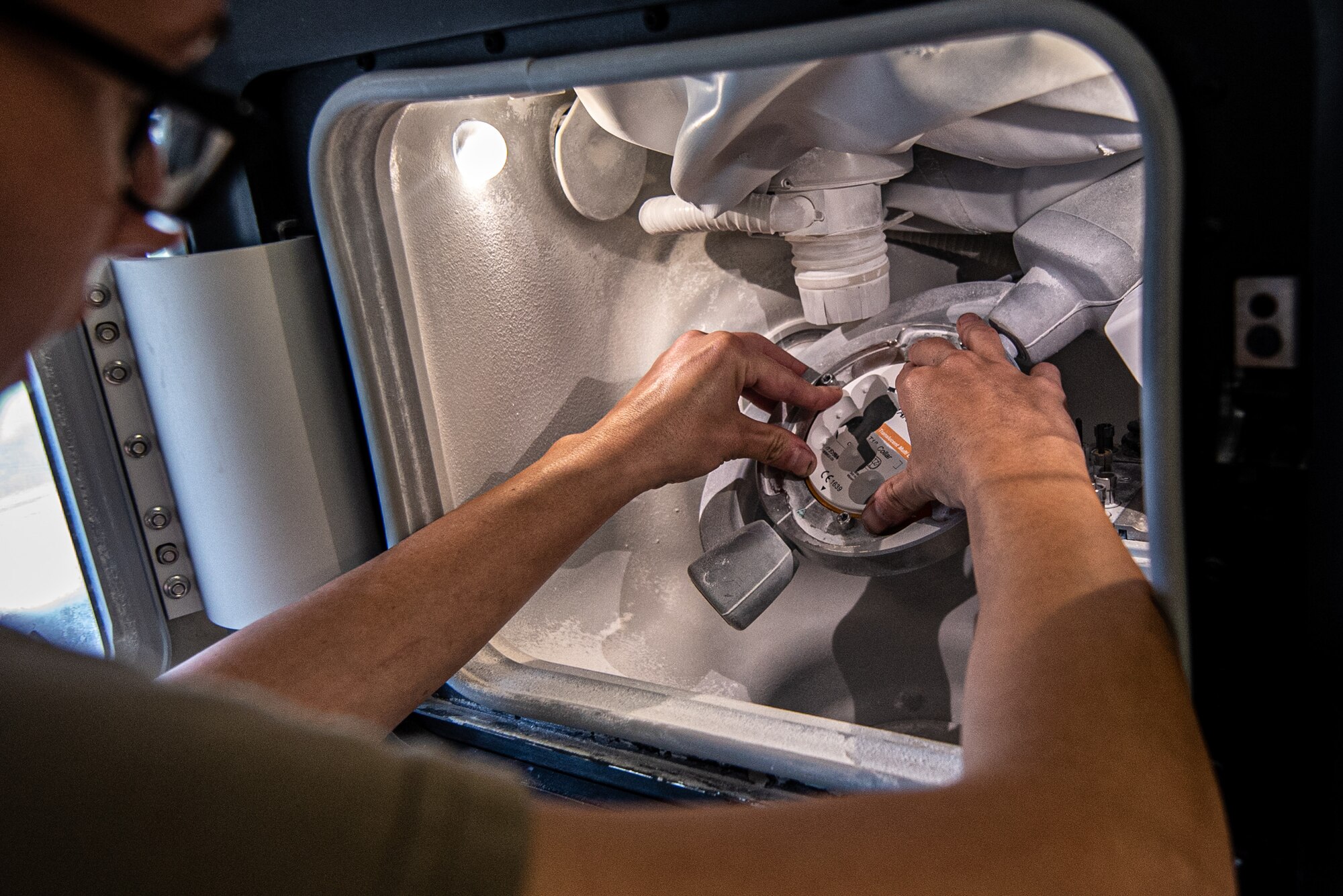 An Airman places a tooth mold into a machine.