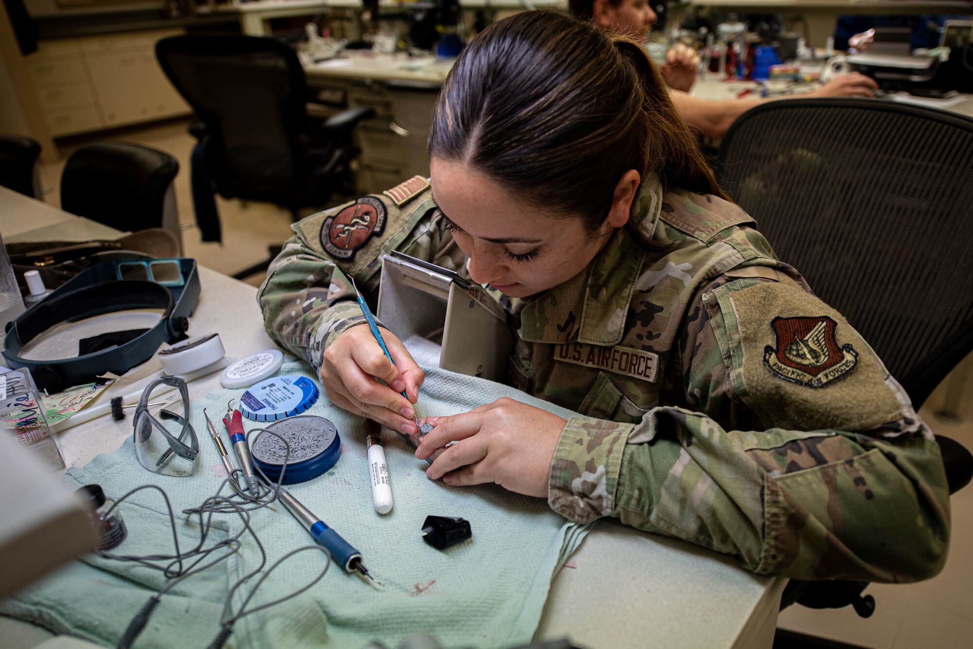 An Airman makes a wax mold.