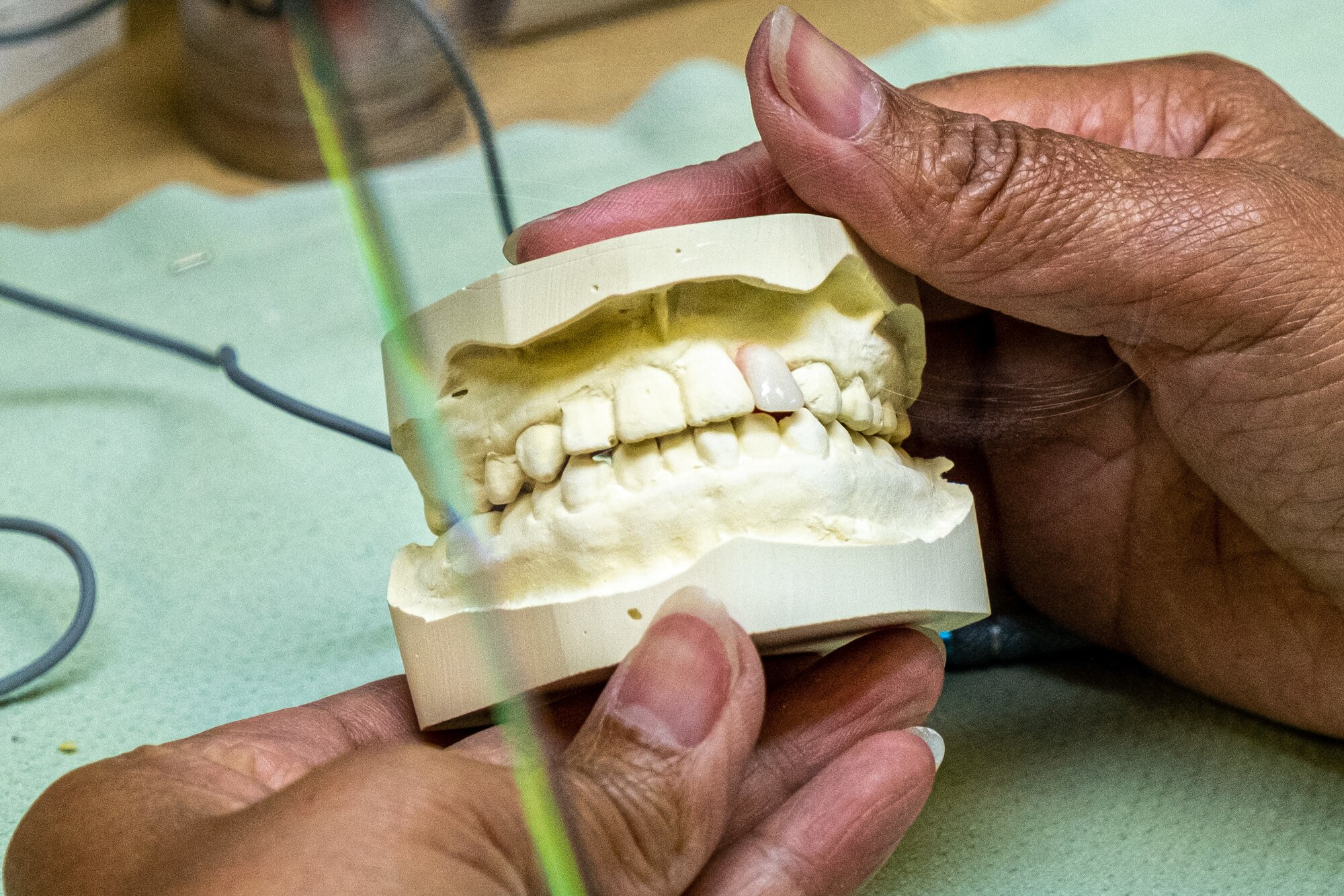 A woman checks the fit of a denture.