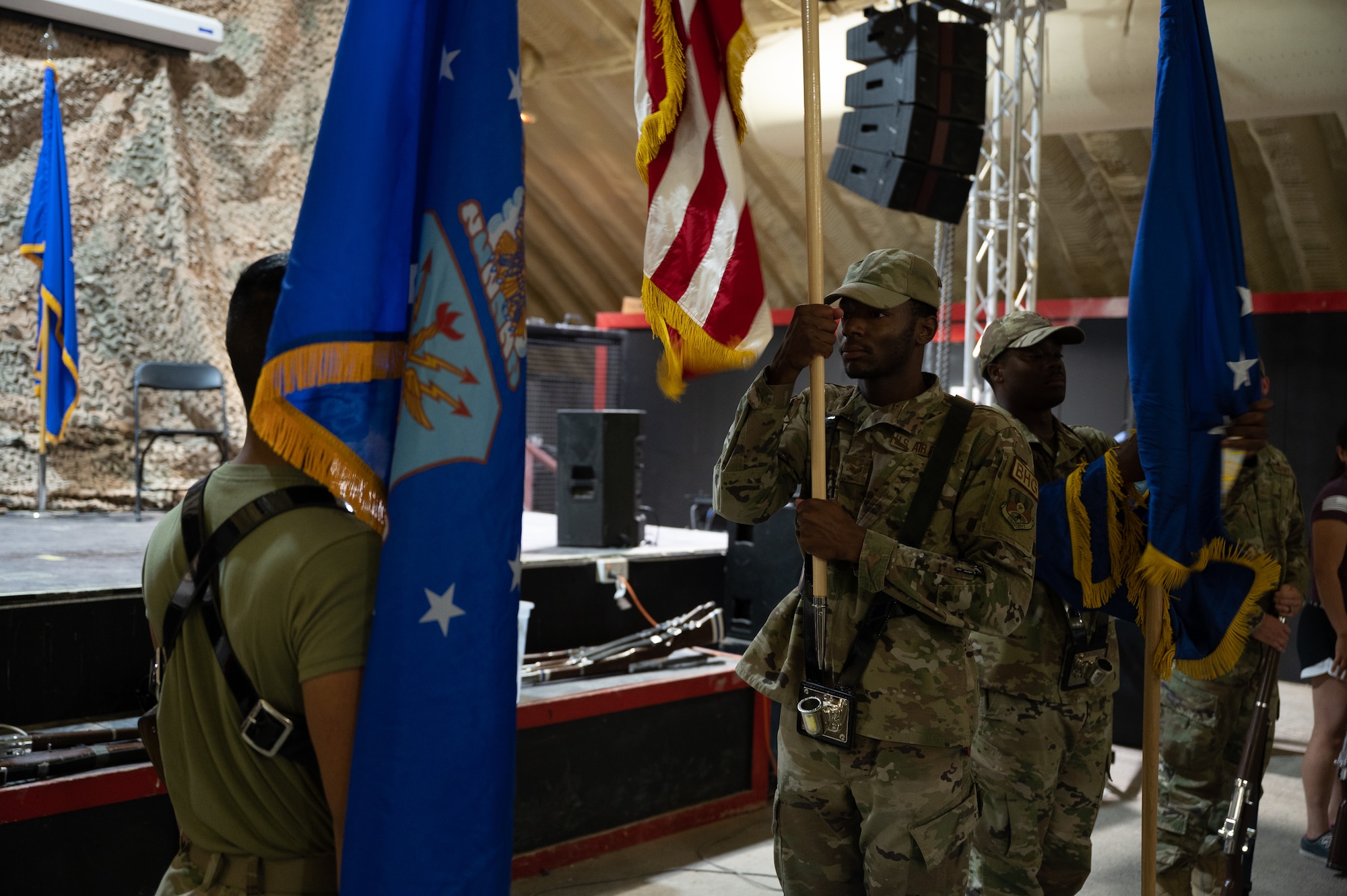 Senior Airman Shawn Reid, 332d Expeditionary Comptroller Squadron customer service cashier, demonstrates how to properly raise the flag during practice at an undisclosed location in Southwest Asia, May 27, 2022. The Honor Guard provides military ceremonial support and dignified transfer support when called upon. (U.S. Air Force photo by Master Sgt. Christopher Parr)