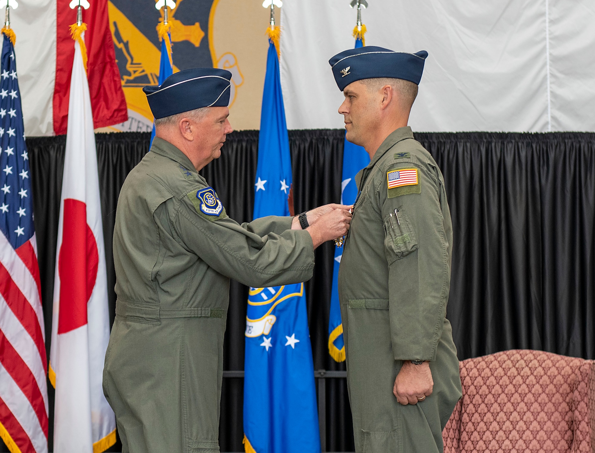 U.S. Forces Japan commander presents a decoration to outgoing 374th Airlift Wing commander