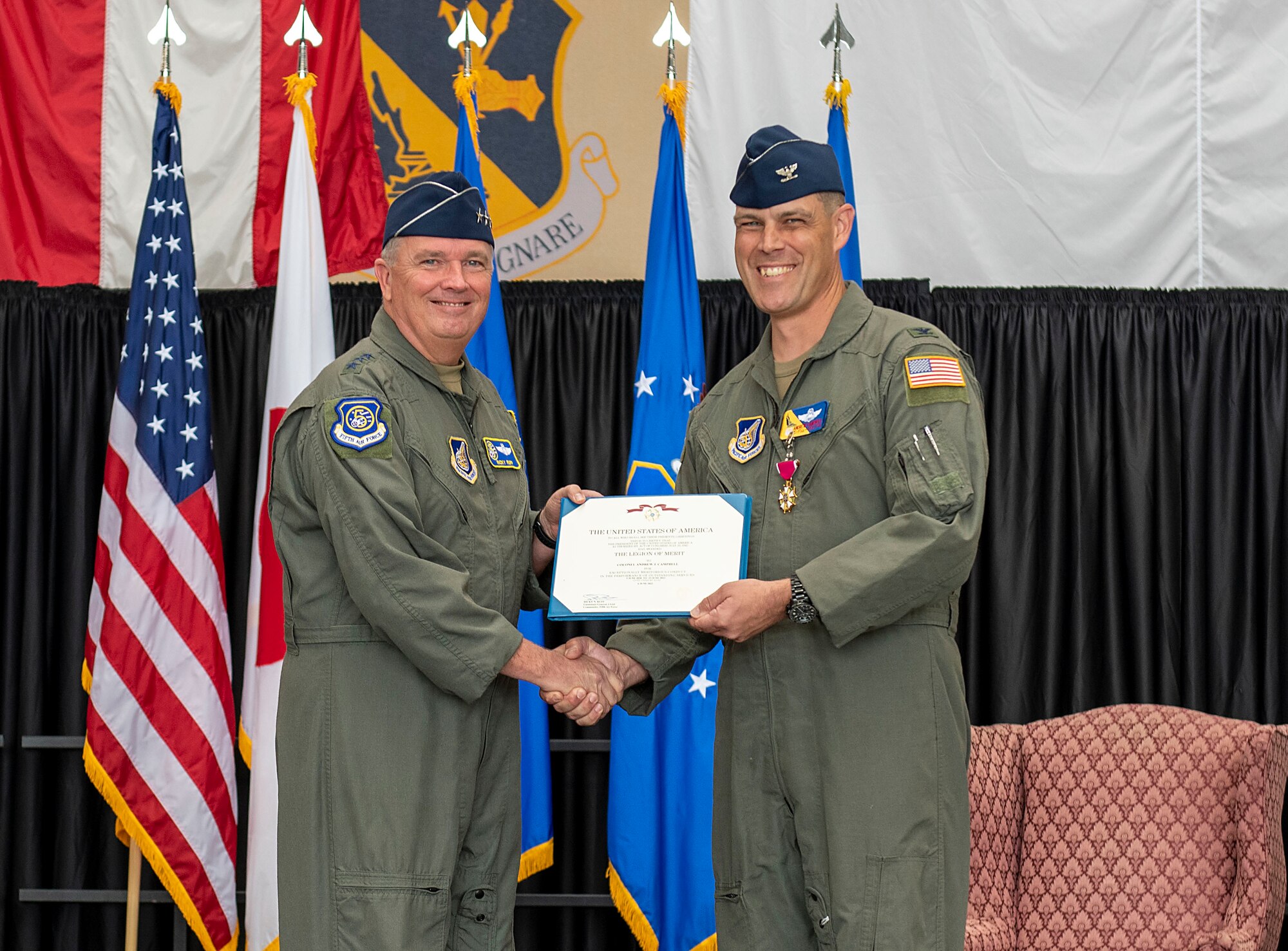 U.S. Forces Japan commander stands with 374th Airlift Wing commander for a photo