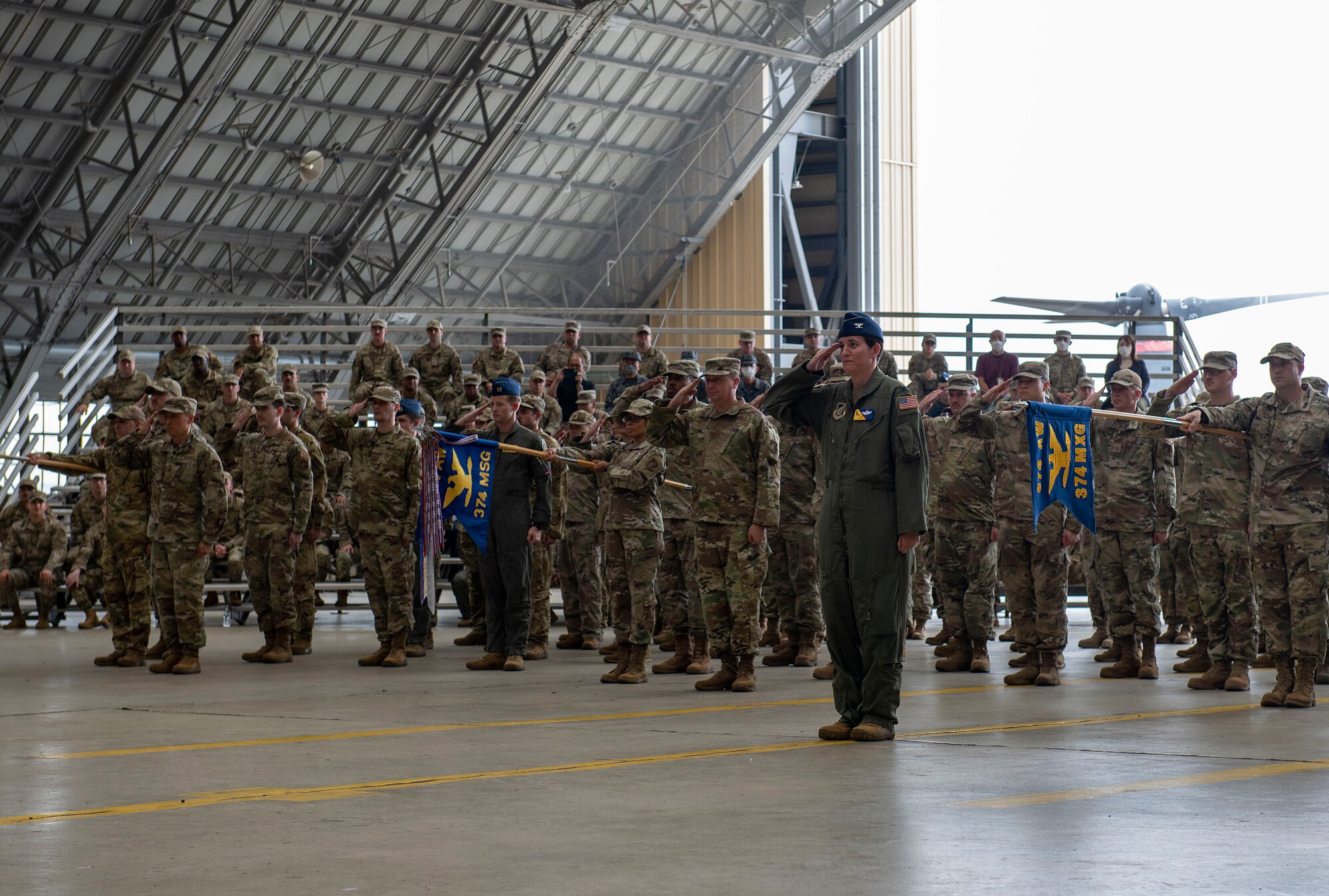 U.S Forces Japan members salute during a ceremony