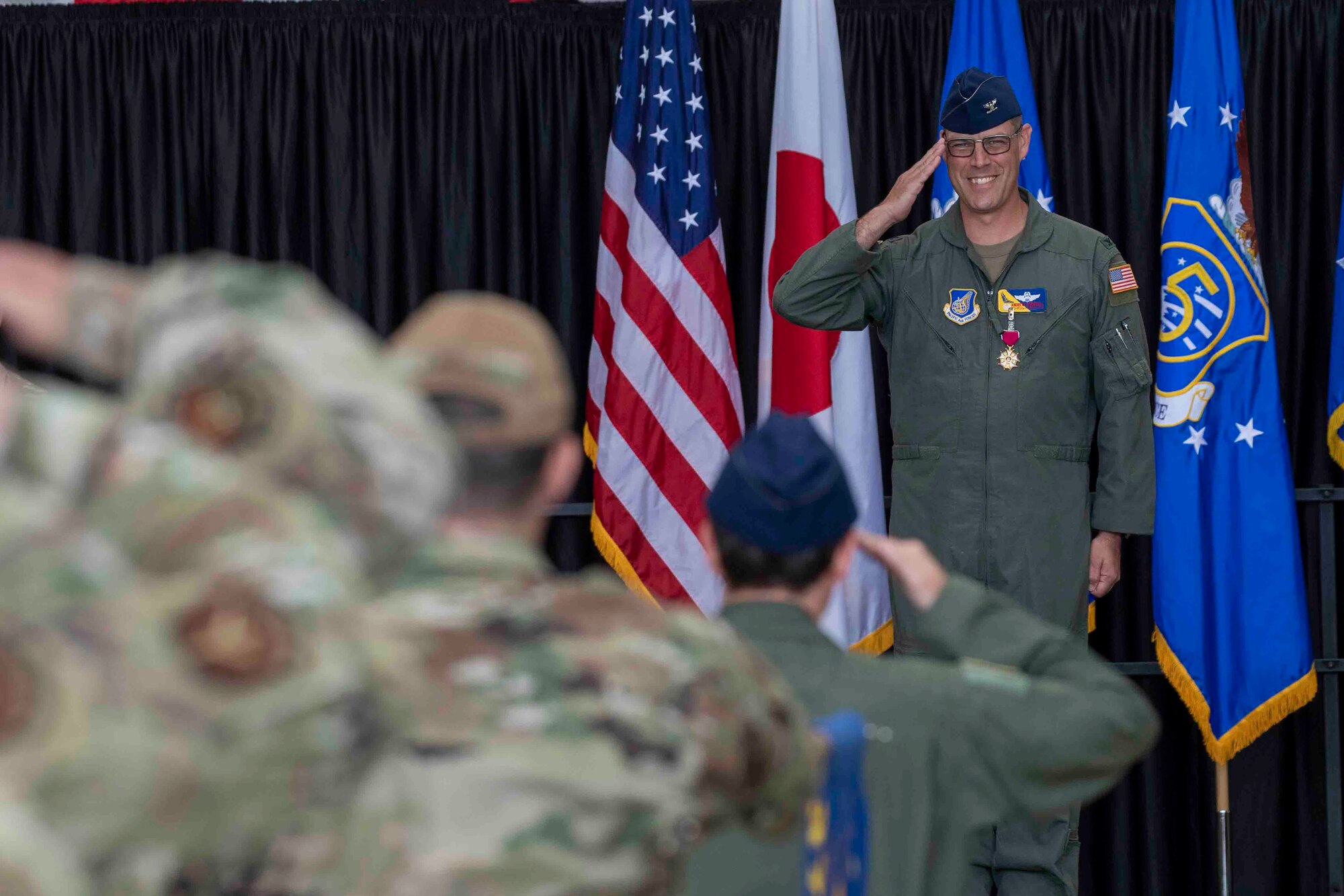 Col. Andrew Campbell, 374th Airlift Wing outgoing commander, renders his final salute as commander