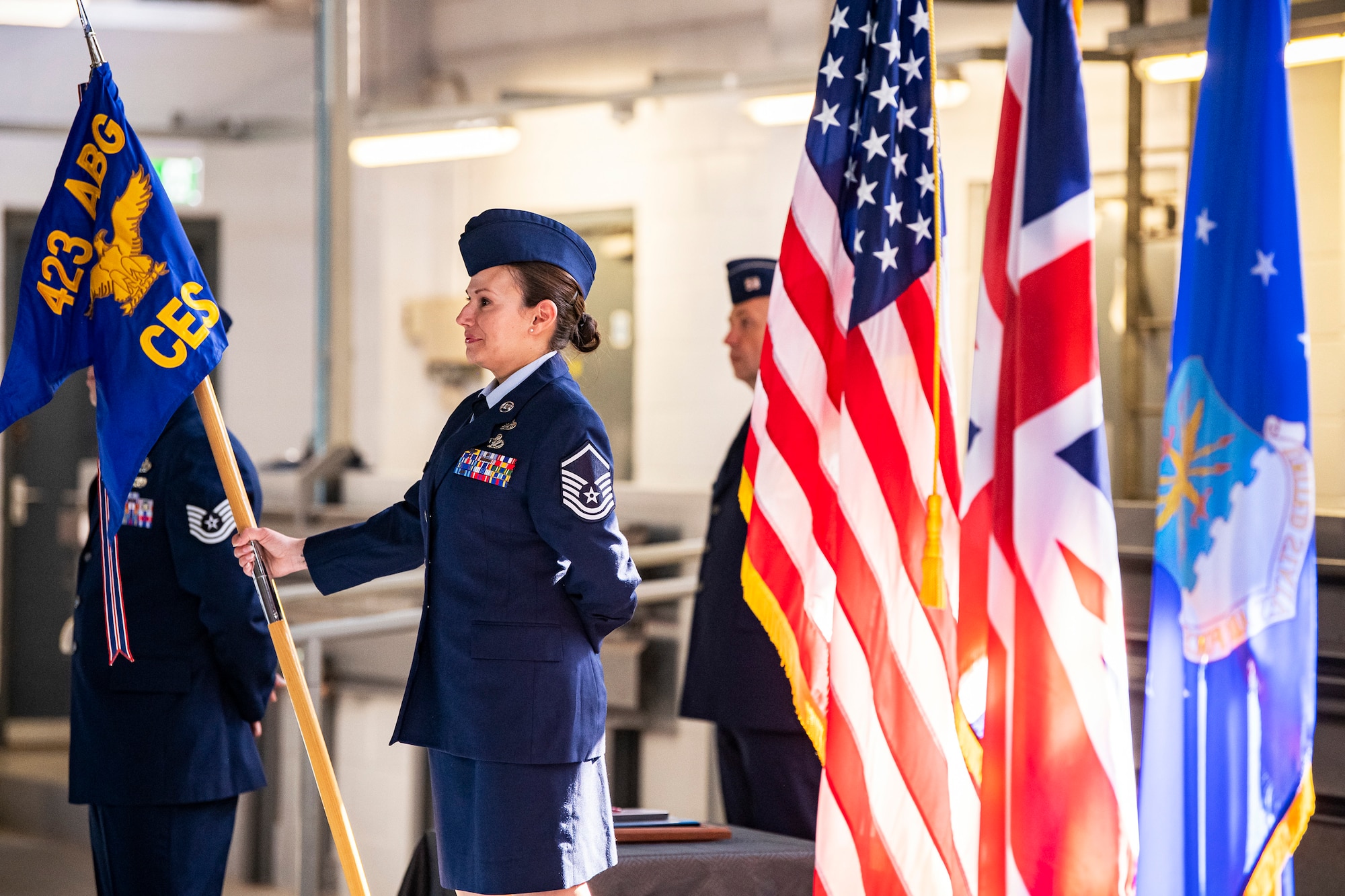 U.S. Air Force Master Sgt. Terri Adams, 423d Civil Engineer Squadron superintendent, holds the guidon during a change of command ceremony at RAF Alconbury, England, June 22, 2022. The ceremony is a military tradition that represents a formal transfer of a unit’s authority from one commander to another. (U.S. Air Force photo by Staff Sgt. Eugene Oliver)