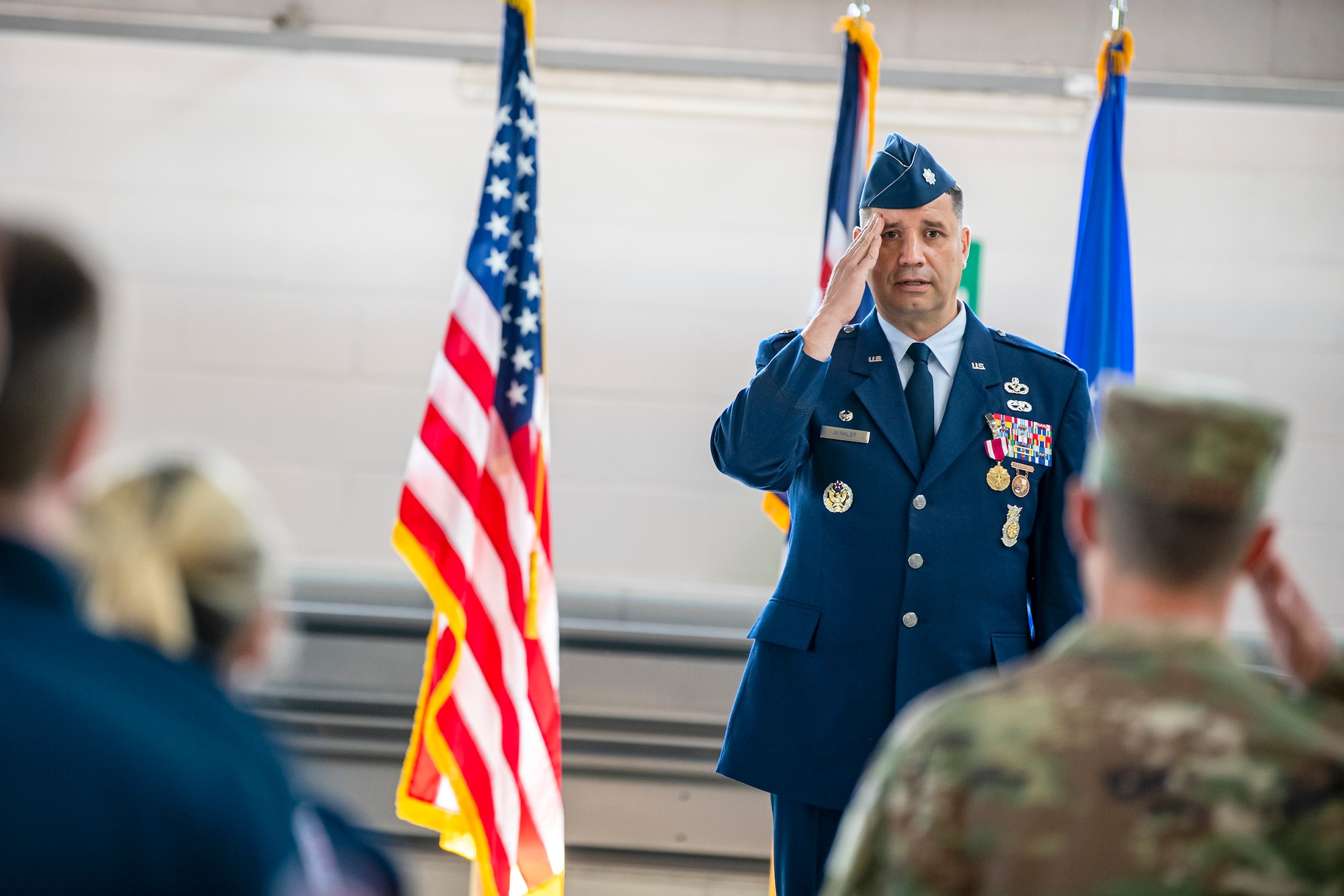 U.S. Air Force Lt. Col. Hans Winkler, center, 423d Civil Engineer Squadron outgoing commander, renders a final salute to the Airmen of the 423d CES during a change of command ceremony at RAF Alconbury, England, June 22, 2022. During his command, Winkler led a multinational workforce of 196 military and civilian personnel in the sustainment, maintenance, repair, fire protection and emergency services for 697 facilities across a two-installation and 916 acre complex. (U.S. Air Force photo by Staff Sgt. Eugene Oliver)