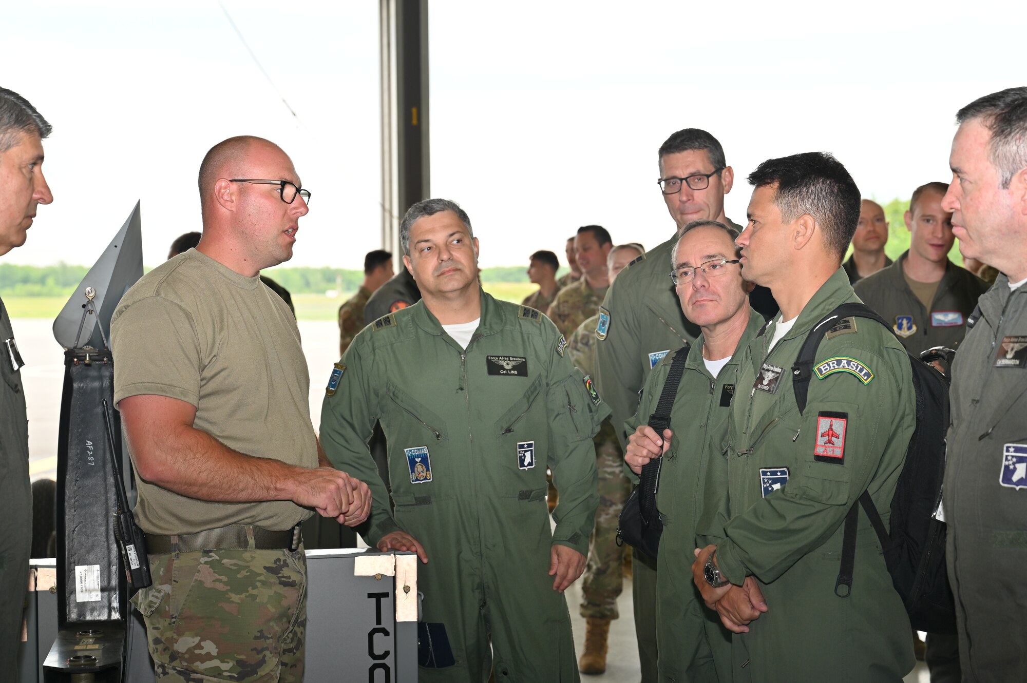 HANCOCK FIELD AIR NATIONAL GUARD BASE, SYRACUSE, NY. --  Master Sgt. Eric Wintersteen, a crew chief with the 174th Maintenance Group, is explaining how he is performing an airframe and engine inspection on the MQ-9 reaper to members from the Brazilian military on June 6, 2022 at Hancock Field Air National Guard base. The Brazilian military’s purpose for the visit is to strengthen the partnership between the New York Air National Guard and the Brazilian Air Force Aerospace Operations Command. (U.S. Air National Guard photo by Master Sgt. Barbara Olney)